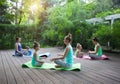 Mothers and daughters doing exercise practicing yoga outdoors Royalty Free Stock Photo