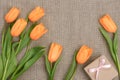 Mothers Day background. Tulips, gift on sackcloth