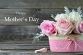 Mothers Day card. Pink roses in basket on wooden background Royalty Free Stock Photo