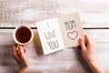 Mothers day composition. Hands holding note. Studio shot. Royalty Free Stock Photo