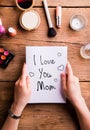 Mothers day composition. Woman with note. Beauty products. Royalty Free Stock Photo