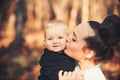 Mothers day concept. Mother kiss little son with love. Woman hug child. Mom and baby boy outdoor. Happy family enjoy Royalty Free Stock Photo