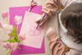 Mothers Day.daughter makes a card for his mother.Flowers and cards for mom.Daughter draws a card for mom.Message to mom Royalty Free Stock Photo