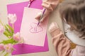 Mothers Day.Flowers and cards for mom.Daughter draws a card for mom.Message to mom.Child draws a heart and writes mom I Royalty Free Stock Photo