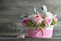 Mothers Day flowers. Pink roses in basket on wooden background Royalty Free Stock Photo