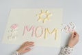 Mothers Day. A gift to the child mom, drawing an applique from marshmallow Royalty Free Stock Photo