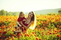 Mothers day, girl and little boy in field of poppy Royalty Free Stock Photo