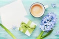 Mothers Day greeting background with holiday postcard, flowers, gift or present box and cup of coffee on table top view. Royalty Free Stock Photo