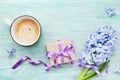 Mothers Day greeting background with hyacinth flowers, gift or present box and cup of coffee top view. Royalty Free Stock Photo