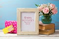 Mothers day greeting card with rose flower bouquet, gift box and photo frame