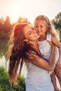Mothers day. Happy woman playing and having fun with little daughter in spring park holding kid and laughing. Family Royalty Free Stock Photo