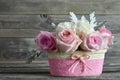 Mothers Day roses. Pink roses in basket on wooden background Royalty Free Stock Photo