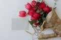 Mothers day. Stylish red tulips bouquet, greeting card, gift, scissors, twine on rustic white wood Royalty Free Stock Photo