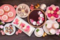 Mothers Day table scene with assorted desserts and sweets, overhead on dark wood Royalty Free Stock Photo
