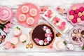 Mothers Day table scene with an assortment of desserts and sweets, above view on white wood Royalty Free Stock Photo
