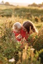 Mothers day. womens day. Portrait of smiling beautiful young woman and her little daughter sitting on grass, against green of Royalty Free Stock Photo