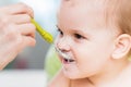 Mothers feeding the baby with cottage cheese