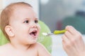 Mothers feeding the baby with cottage cheese