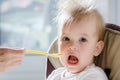 Mothers feeding the baby with cottage cheese