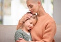 Mothers feel their childrens pain the deepest. a young mother comforting her daughter on the sofa at home.