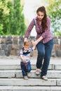 Mom insures her child during a walk