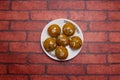 Motichur Laddu sweet topping with almonds served in plate isolated on background top view of bangladeshi dessert food