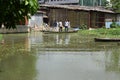 MOTIJHEEL,DHAKA/BANGLADESH-JULY 09 2020: Small Wooden Boat Carry Passenger In Small Lake Near Central Bank Of Bangladesh