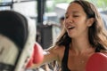 Motion blur of athletic strong woman boxer slim body training defensive guard with boxing gloves practicing with coach