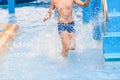 Motion blur boy running in pool. Royalty Free Stock Photo