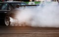 Motion blur of Car drifting, Blurred of image diffusion race drift car with lots of smoke from burning tires on speed track Royalty Free Stock Photo