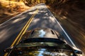 Motion blur of car driving down a road during Fall