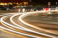 Motion Blur Of Car Headlights Turning At Busy Intersection