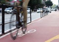 Motion blur of cyclist over red lane. Royalty Free Stock Photo