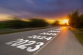 Motion blur empty asphalt road and New year 2023 concept. Driving on an empty road to Goals 2023 with sunset Royalty Free Stock Photo