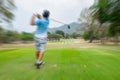 Motion blur golfer swinging driver Royalty Free Stock Photo