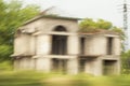 A motion blur image of an unfinished and abandoned roadside building