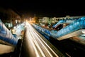 Motion blur light lines of rushing cars on the bright street of night city Royalty Free Stock Photo