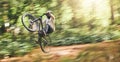 Motion blur of mountain bike man, action jump and bicycle speed adventure, freedom and fast race in woods. Cycling Royalty Free Stock Photo