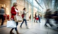 motion blur of people with shopping bags in a busy shopping mall. retail sale and discount Royalty Free Stock Photo