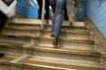 Motion blur of peoples legs climbing flight of steps suggesting movement and hurry Royalty Free Stock Photo