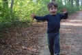 Motion blur photo, unfocused. joyful baby boy in a blue sweater running through the forest. Royalty Free Stock Photo