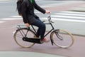 motion blur picture of a man riding a bicycle on a city street Royalty Free Stock Photo