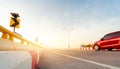 Motion blur of red car driving on curve concrete road with traffic sign. Road trip on summer vacation. Car drive on the street.