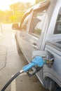 Refueling Car fills with petrol gasoline at a gas station and Petrol pump filling fuel nozzle in the fuel tank of the car Royalty Free Stock Photo