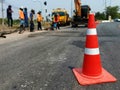 Motion blur, road construction with a red rubber cone in front Royalty Free Stock Photo