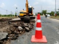 Motion blur, road construction with a red rubber cone in front Royalty Free Stock Photo