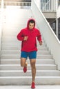 Motion blur sport man in red hood running down Royalty Free Stock Photo