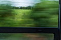 Motion blur train window view with green trees and sky Royalty Free Stock Photo