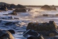 Motion blur wave breaking rocky shoreline sunrise Royalty Free Stock Photo