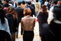 Motion blur of woman from behind crossing street